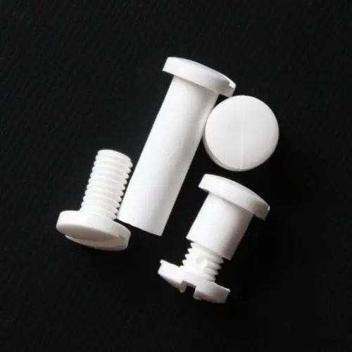 A set of 1" White Plastic Screw Posts with a snap-lock mechanism, designed for securely binding materials such as documents, swatches, or lightweight panels, displayed on a black background for clear visibility.
