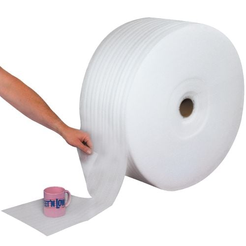 A Parcel Ready Perforated Air Foam Roll is shown dispensing pre-cut foam sheets, with a person tearing off a section to wrap around a fragile pink coffee mug for protective cushioning.