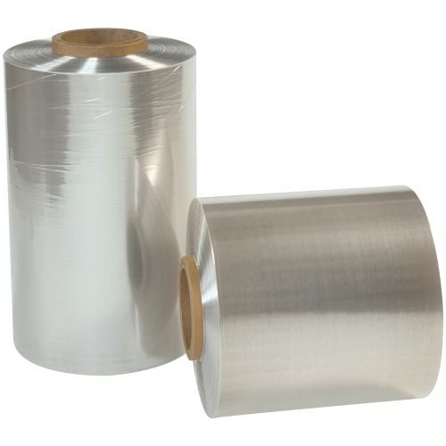 Two rolls of 75 Gauge 10" x 500' Reynolon® 5044 PVC Shrink Film with a glossy, transparent finish are displayed, one standing upright and the other lying horizontally, both tightly wound around sturdy cardboard cores.