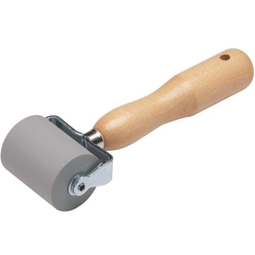 The 3M™ Safety-Walk™ Hand Roller features a large gray rubber roller mounted on a sturdy metal frame, with a smooth wooden handle designed for comfortable grip, ideal for pressing down safety walk tapes securely onto surfaces.