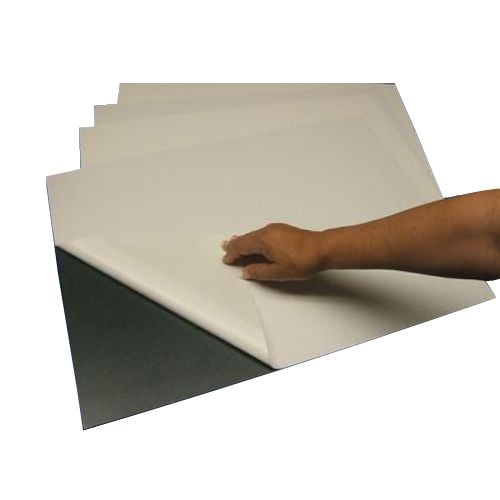 A hand peeling back the adhesive liner on a Black 3/16" Gator Mounting Board with Permanent Adhesive, showing its smooth surface and sturdy construction.