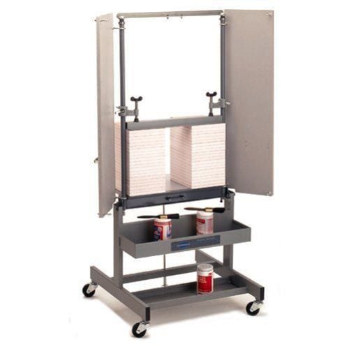 Challenge Paddy Wagon Heavy Duty Padding Press, featuring a sturdy metal frame with a clamping mechanism and shelves for holding padding supplies. Challenge Paddy Wagon Heavy Duty Padding Press, featuring a sturdy metal frame with a clamping mechanism and shelves for holding padding supplies.