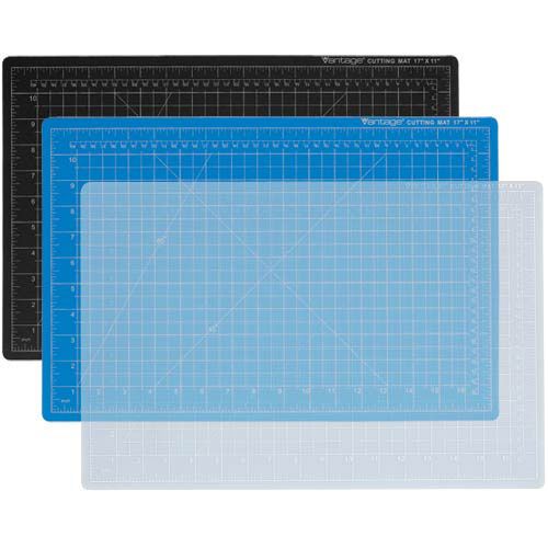 Three Dahle 24" x 36" Vantage Blue Self-Healing Cutting Mats are stacked, showcasing their blue, black, and clear grid-lined surfaces with precise measurement markings.