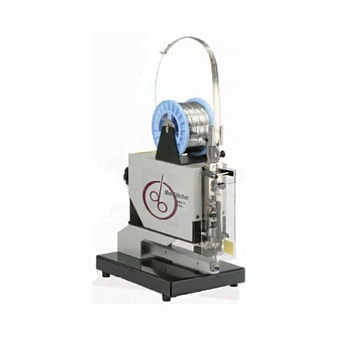 DeLuxe MiniStitcher IMS-A25 Saddle Stitching Machine, showcasing its compact design with a spool of wire mounted on top.