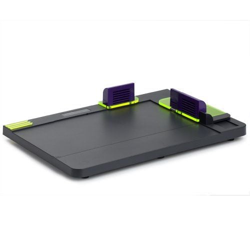 A Fastback Hardcover Guide device, featuring a sleek black platform with purple and neon green elements used for aligning and binding hardcover books.