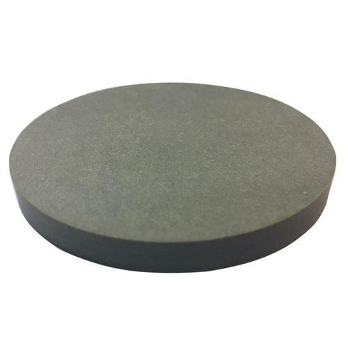 A circular, dark gray disk resembling a 2-1/2" x 1/4" Fiber Drill Block is shown with a smooth surface and uniform thickness, indicative of precision machining for industrial applications.