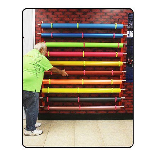 A colorful display of rolls on a "Mondo Raxx Jumbo Mountable Media Roll Storage" system mounted against a brick wall.
