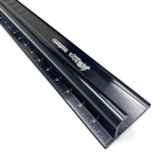 A black Sooper Edge Ultimate Safety Ruler - Standard Sizes, featuring a curved safety edge and precise measurement markings in inches and centimeters.