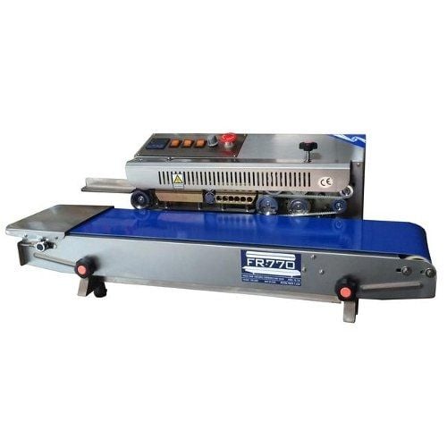 SealerSales FR-770I Horizontal Continuous Band Sealer (Left Feed) with a stainless steel body and blue conveyor belt, designed for efficient heat sealing, featuring control buttons, a red emergency stop button, and a compact design.