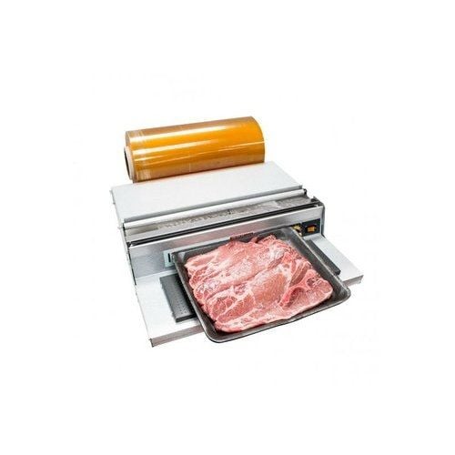 A SealerSales U-450 17" Stainless Steel Hand Wrapper with a PTFE-coated heat plate, showcasing a plastic-wrapped tray of marbled meat with a roll of wrap in the background.