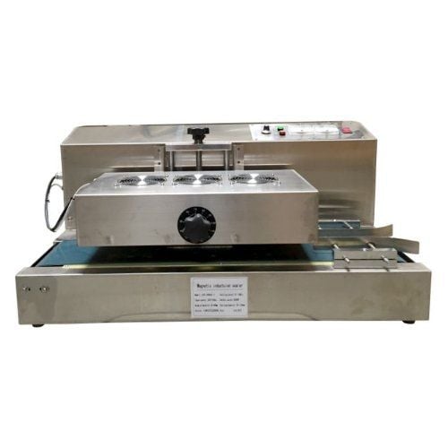 A stainless steel SealerSales Table-Style Continuous Induction Sealer with a conveyor belt system, cooling fans on top, and control buttons on the side, designed for sealing operations in industrial settings.