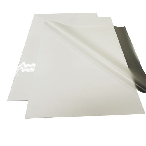 A set of White Heavy Duty 1/4" Thick Gloss Pouch Laminating Boards, with one partially peeled to show its glossy laminated surface.