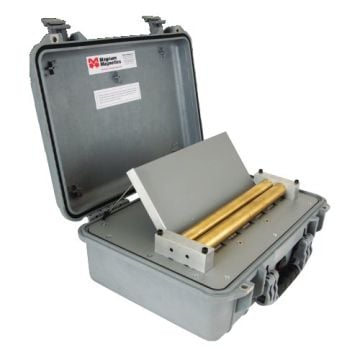 A portable desktop magnetizer, the High Energy PDM16-HE 13, featuring a sturdy gray case with an open lid revealing dual brass rollers and a metallic slanted surface, designed for precise magnetization tasks.