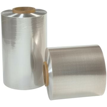 Two rolls of 75 Gauge 10" x 500' Reynolon® 5044 PVC Shrink Film with a glossy, transparent finish are displayed, one standing upright and the other lying horizontally, both tightly wound around sturdy cardboard cores.
