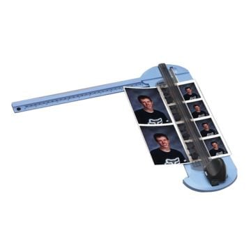 A Carl 12" Deluxe Personal 7 Sheet Rotary Trimmer in use, cutting multiple photo prints with precision.