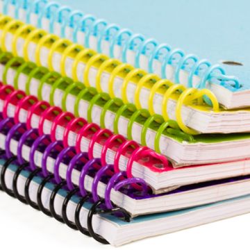 A stack of notebooks bound with Custom Spiral Binding Plastic Coils in various vibrant colors, tightly securing the pages while allowing for flexible and durable page turning.