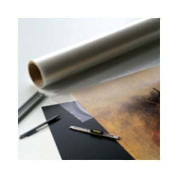 A roll of Drytac Dry Mount Film Mounting Tissue alongside cutting tools and a partially mounted print.