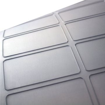 A close-up view of Dyna-Cut Standard Flexible Rotary Dies showcasing their precise rectangular cutting patterns and smooth metallic surface.