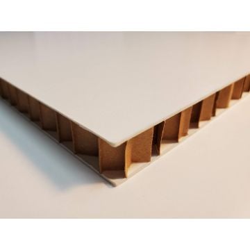 Close-up view of the cross-section of an EagleCell 1/2" Thick Self-Adhesive Biodegradable Mounting Board, showing its honeycomb paper core structure with a smooth white surface.