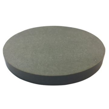 A circular, dark gray disk resembling a 2-1/2" x 1/4" Fiber Drill Block is shown with a smooth surface and uniform thickness, indicative of precision machining for industrial applications.