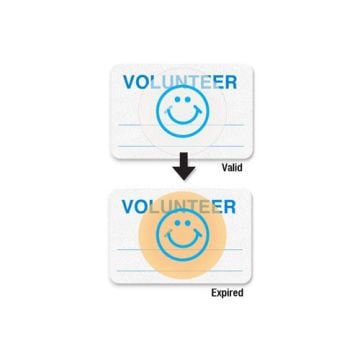 Manual Expiring School Badge - Volunteer displays two badges, with the top labeled "Valid" featuring the word "VOLUNTEER" in blue above a smiling face icon, while the bottom badge marked "Expired" shows the same design with a faded yellow circle indicatin