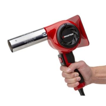 A person holding the SealerSales HG-501D Industrial Master Heat Gun, featuring a red casing, black ergonomic grip, and a metallic nozzle designed for industrial use.