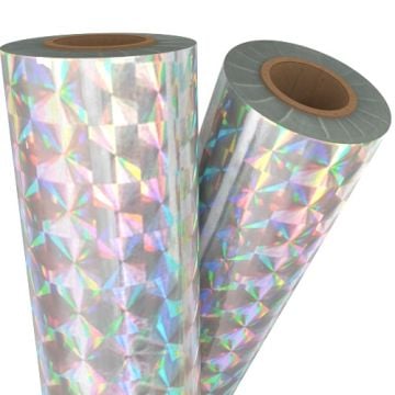 Rolls of Spin Silver Holographic Laminating / Toner Fusing Foil with a vibrant geometric reflective pattern.