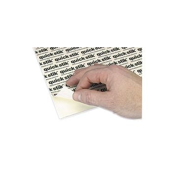 A hand peeling back the adhesive layer of a white 3/16" foam core permanent adhesive mounting board, showcasing the "quick stik" branding on the adhesive surface.