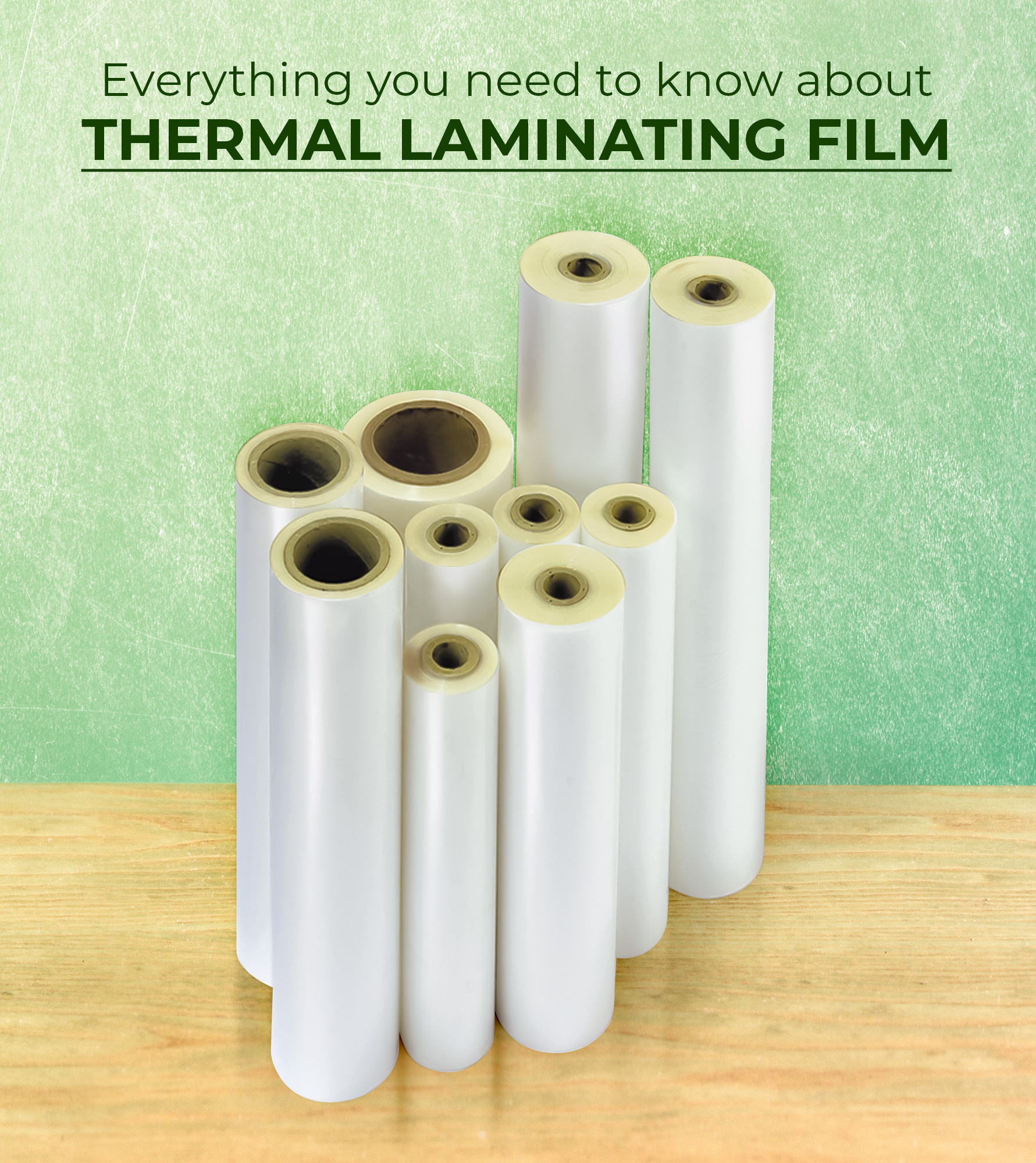 Thermal Laminating Film Rolls stacked against a green office wall at MyBinding.