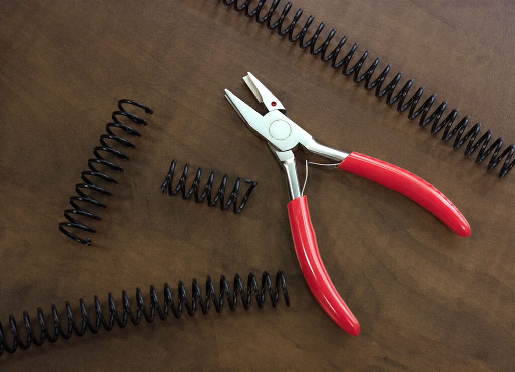 A coil crimper and collection of coil binding.