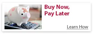 Piggy bank with a bandage sitting on a calculator, representing the concept of 'Buy Now, Pay Later'.